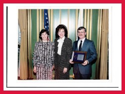 Photo of DOT Secretary Elizabeth Dole with Wayne Braley and Leona Braley at her side as she presented award to Wayne